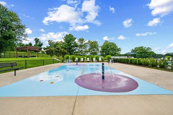 A splash pad with a large fountain in the middle.